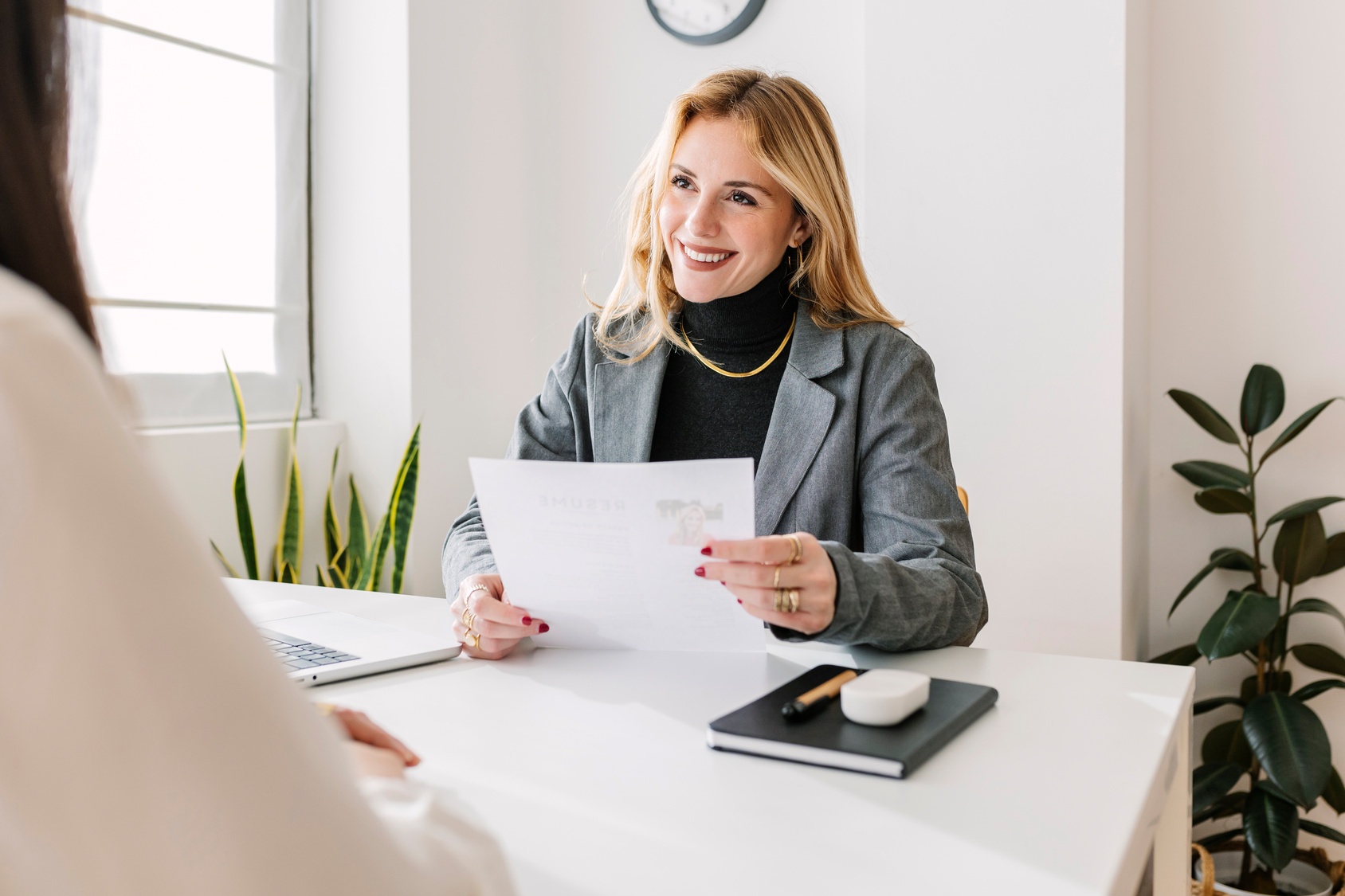 woman smiling behind sheet